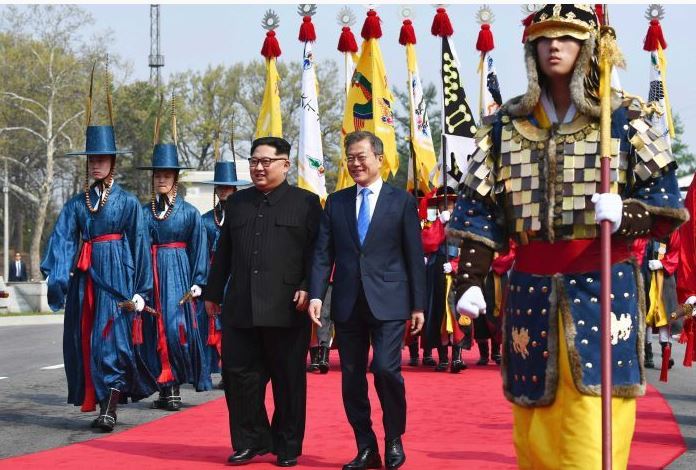 Kim Jong-un and Moon Jae-in walk together at the border village of Panmunjom